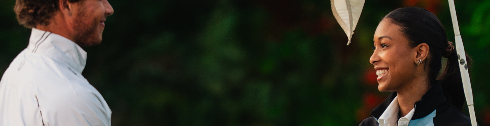 Two people standing close to each other with a blurred background